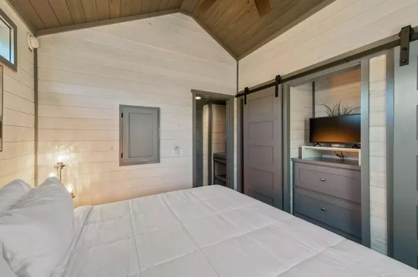a bedroom with a bed and a chandelier