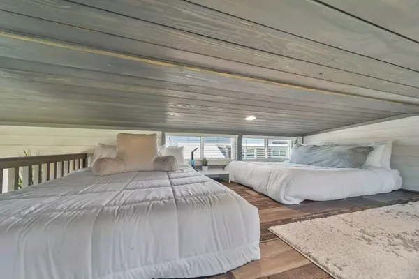 a bedroom with two beds and painted walls