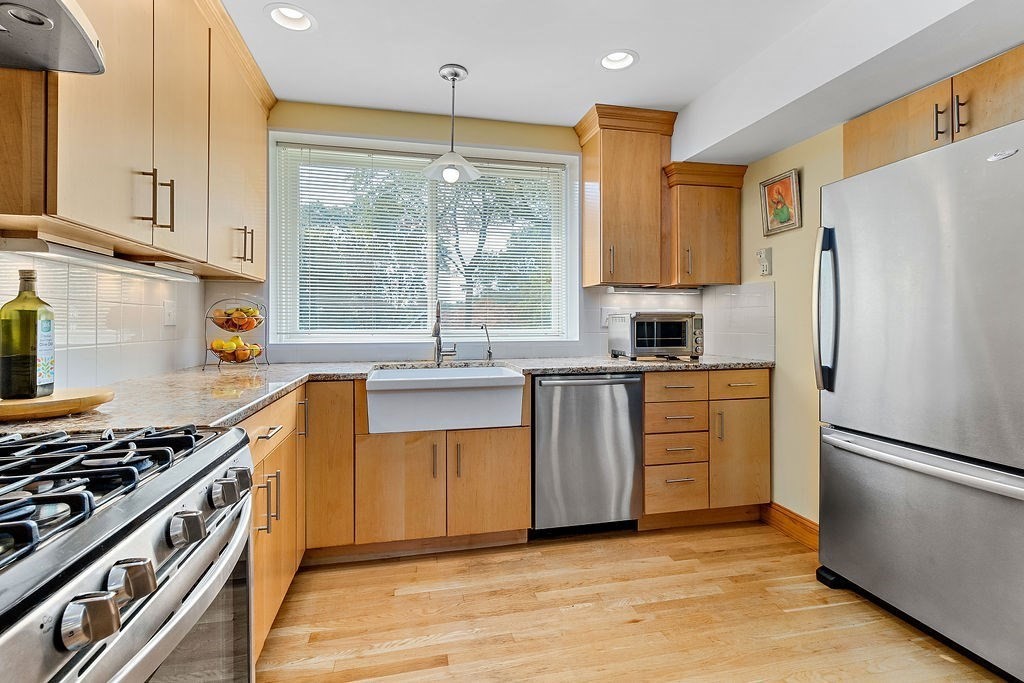 45 Alexander Road Newton, MA 02461 - Photo 8 of 24 a kitchen with kitchen island granite countertop a sink appliances cabinets and a counter top space