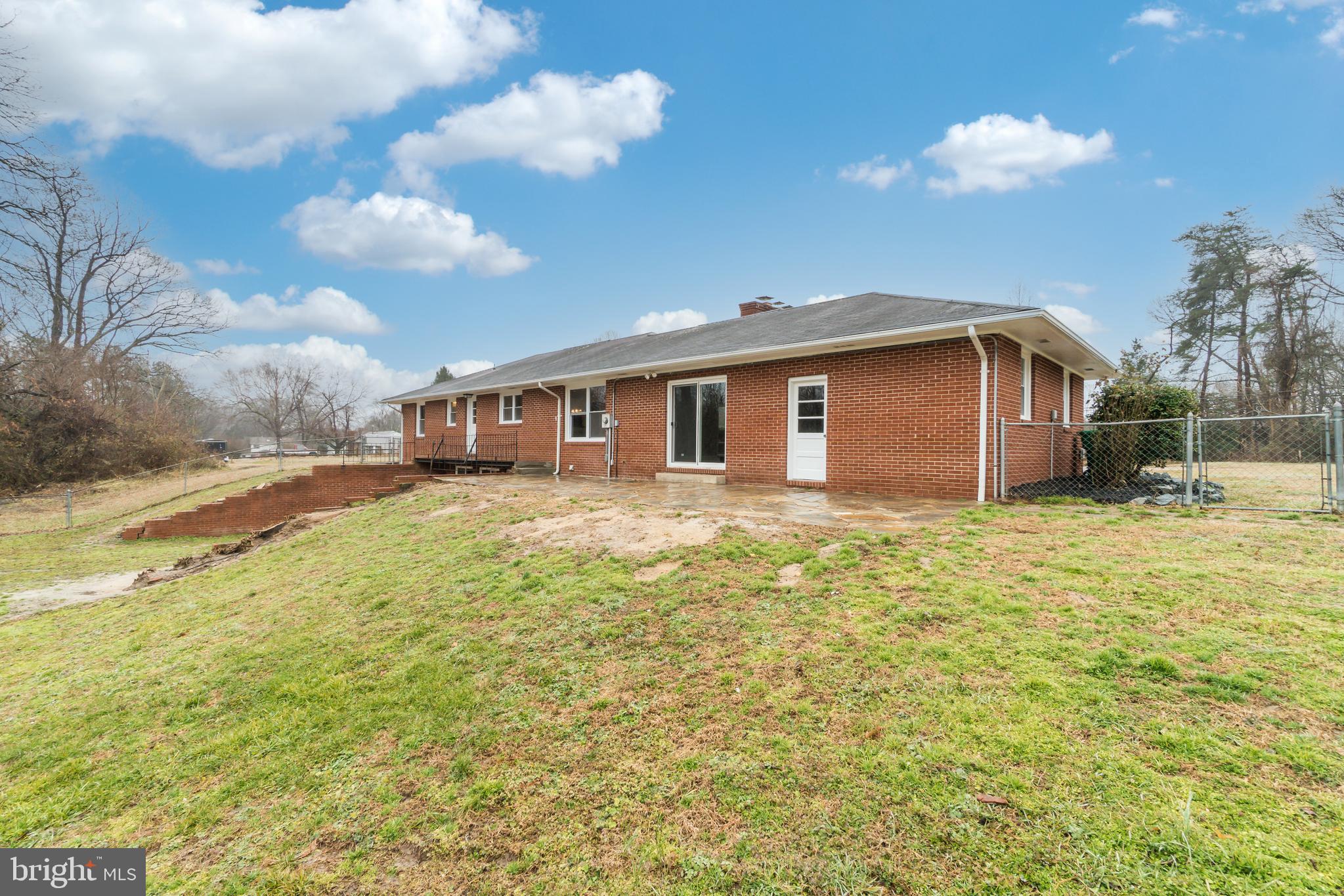 9035 Dahlgren Road King George, VA 22485 - Photo 38 of 38 Rear of home with chain link fence
