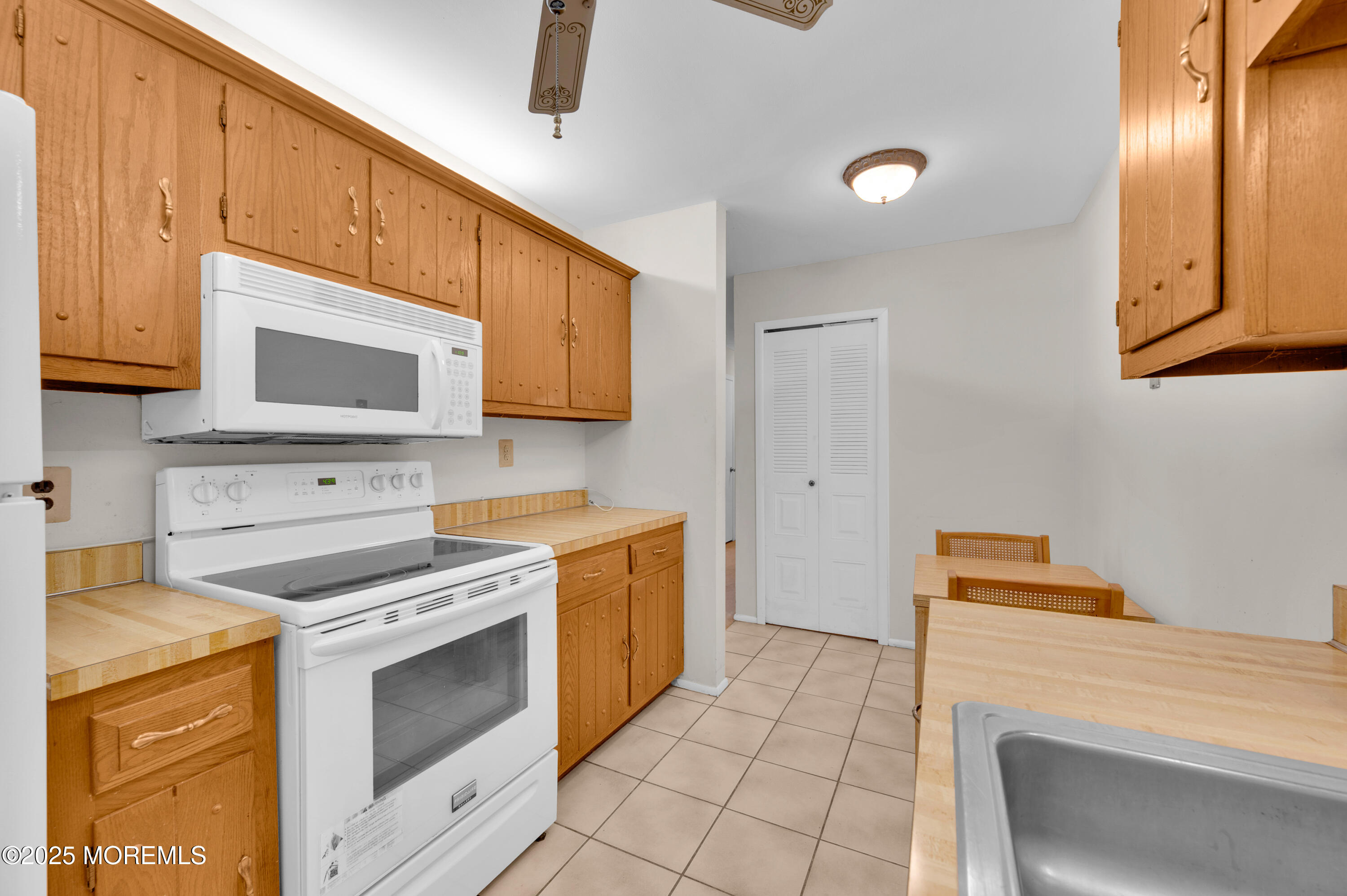 97 Arrowood Road, Unit A Englishtown, NJ 07726 - Photo 13 of 28 a kitchen with granite countertop cabinets stainless steel appliances and a sink