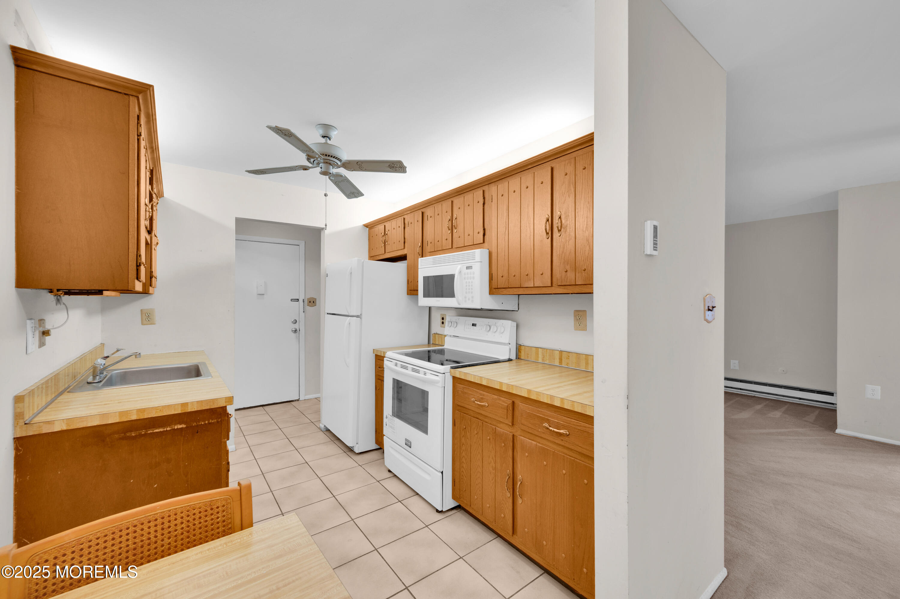 97 Arrowood Road, Unit A Englishtown, NJ 07726 - Photo 16 of 28 a kitchen with stainless steel appliances granite countertop a sink stove and refrigerator