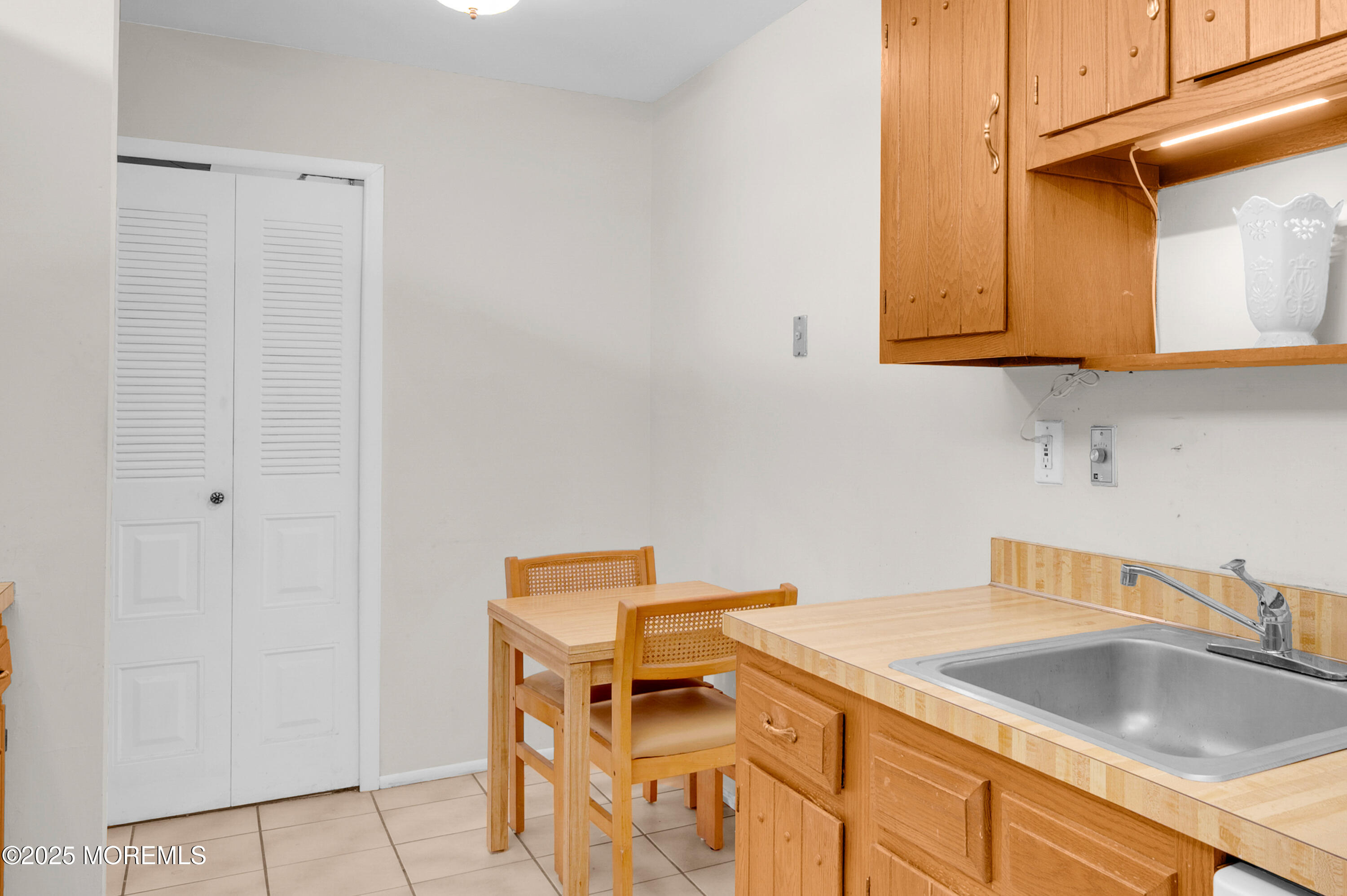 97 Arrowood Road, Unit A Englishtown, NJ 07726 - Photo 17 of 28 a kitchen with a sink and cabinets