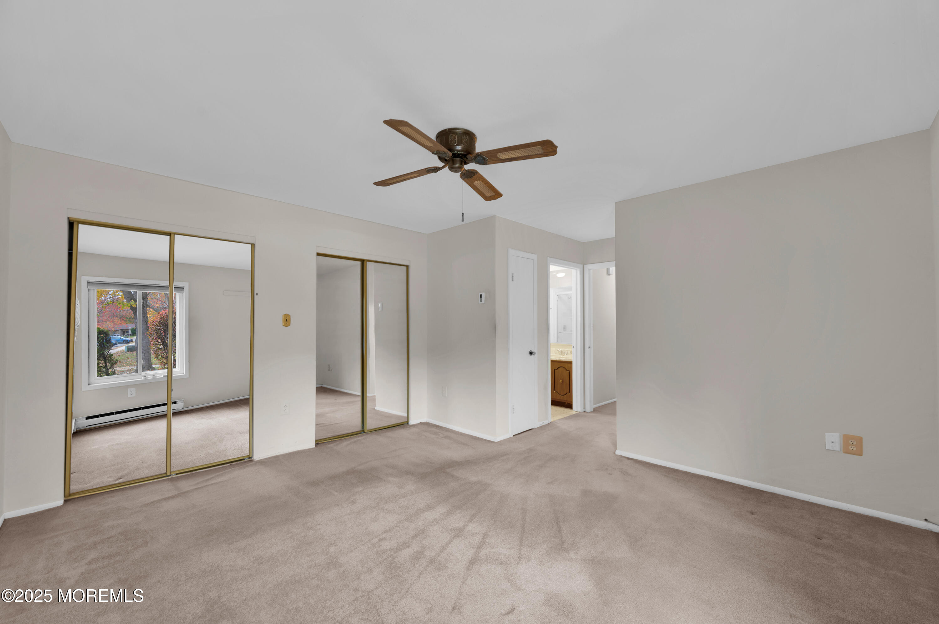 97 Arrowood Road, Unit A Englishtown, NJ 07726 - Photo 24 of 28 a view of a livingroom with a ceiling fan & windows