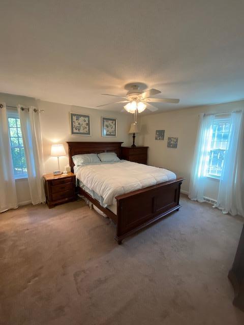 5 Barbary Circle Mashpee, MA 02649 - Photo 21 of 24 a spacious bedroom with a bed and a chandelier