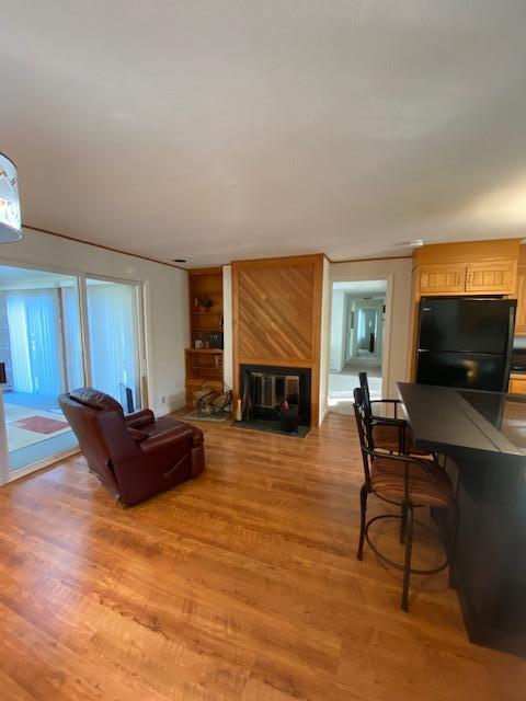 5 Barbary Circle Mashpee, MA 02649 - Photo 8 of 24 a living room with furniture a flat screen tv and a fireplace