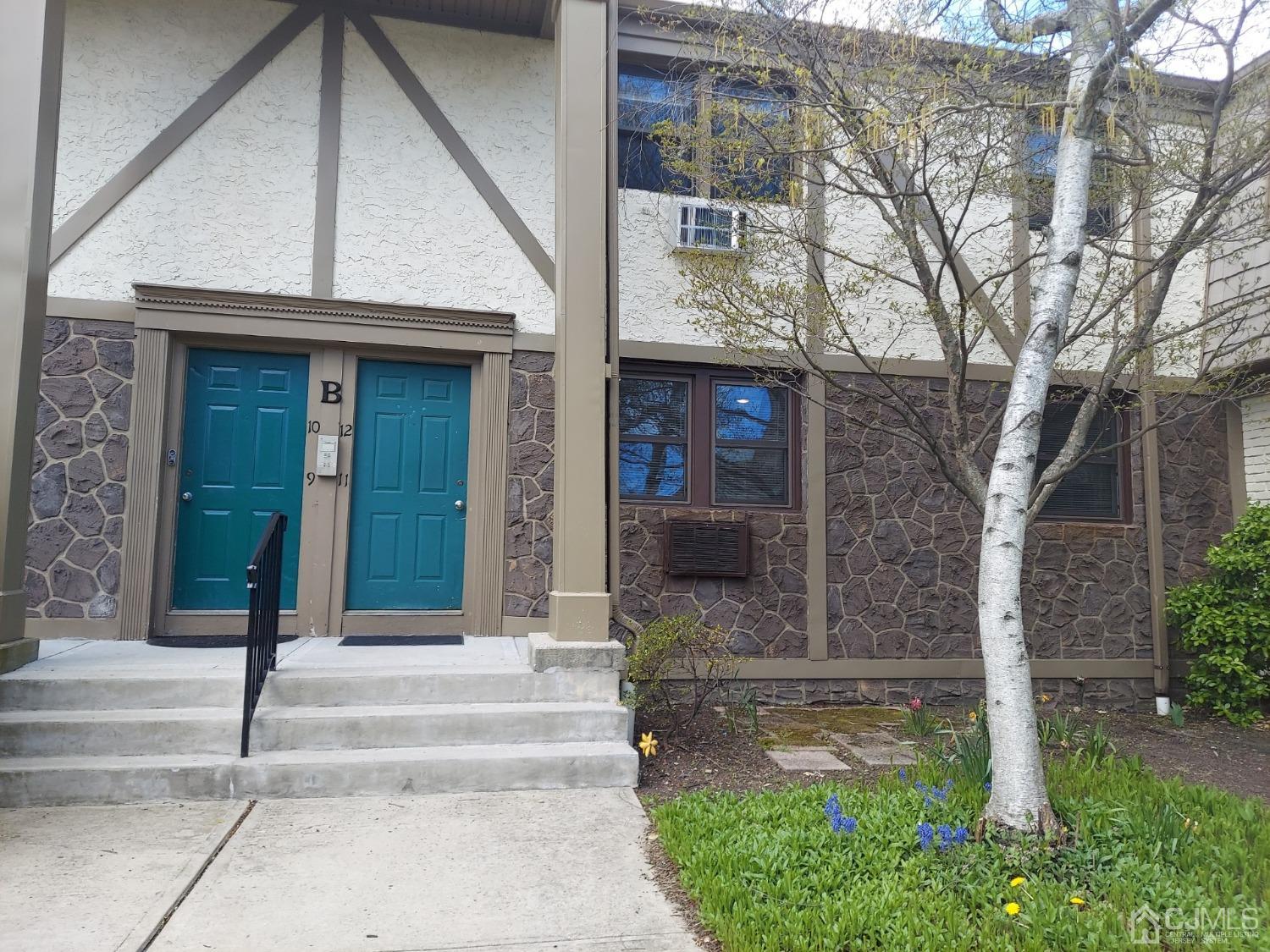 420 Cross Road, Unit B11 Matawan, NJ 07747 - Photo 1 of 9 a front view of a house with garden