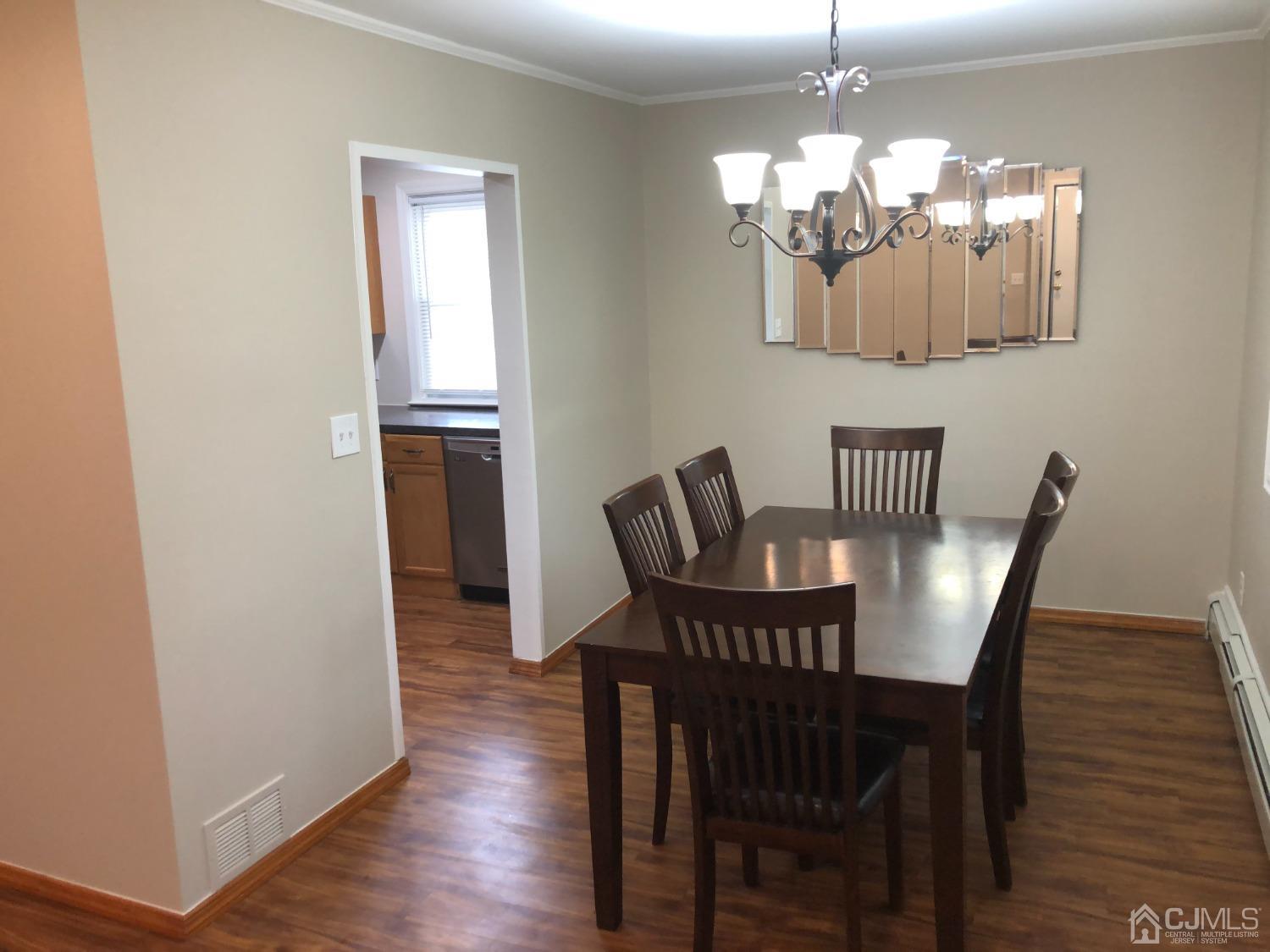 420 Cross Road, Unit B11 Matawan, NJ 07747 - Photo 4 of 9 a view of a dining room with furniture and wooden floor