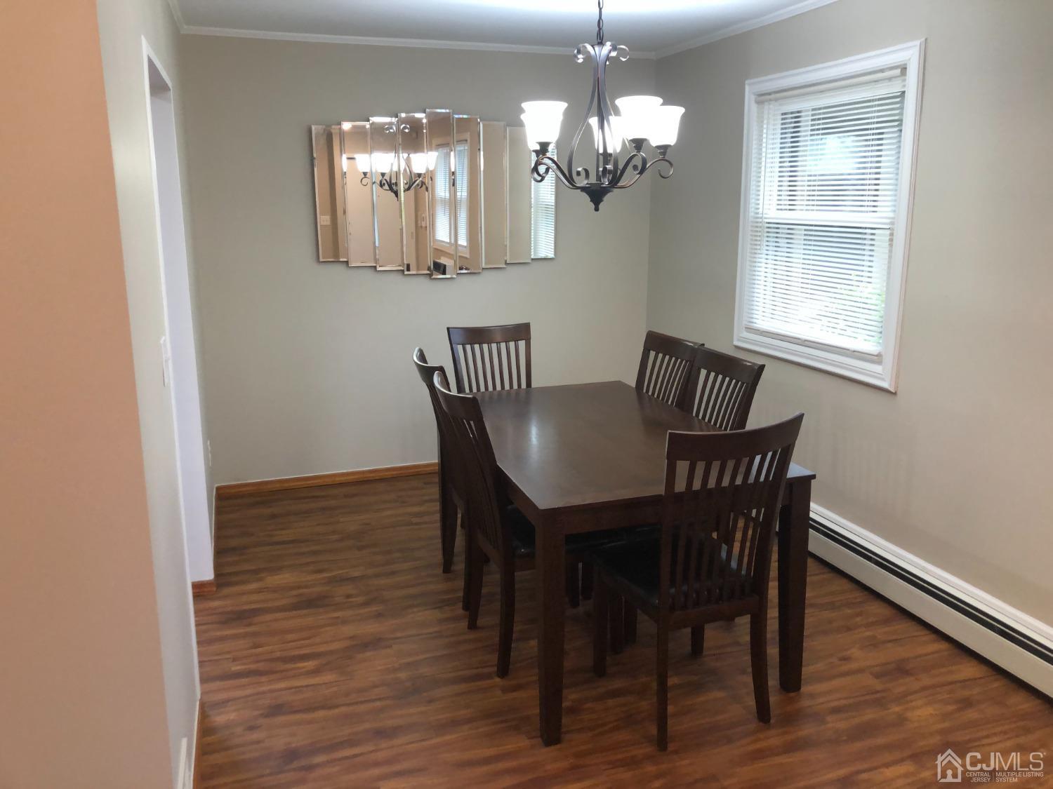 420 Cross Road, Unit B11 Matawan, NJ 07747 - Photo 6 of 9 a view of a dining room with furniture and chandelier