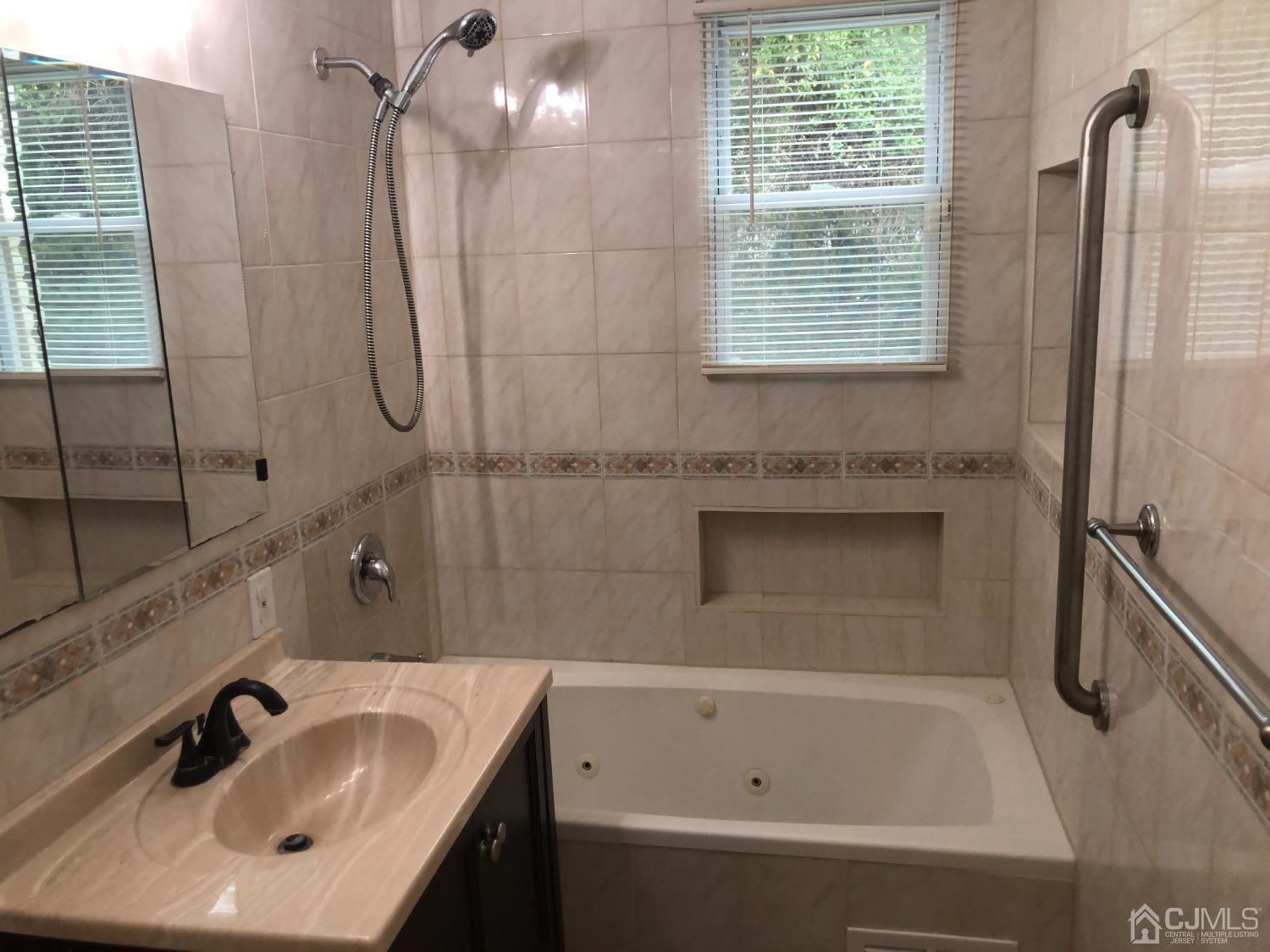 420 Cross Road, Unit B11 Matawan, NJ 07747 - Photo 8 of 9 a bathroom with a sink and a bathtub