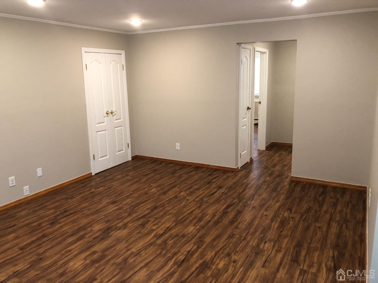420 Cross Road, Unit B11 Matawan, NJ 07747 - Photo 9 of 9 an empty room with wooden floor and windows