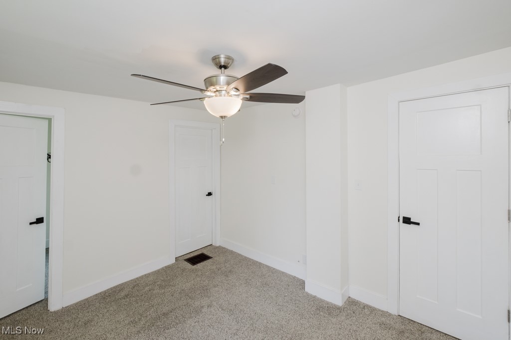 8150 Madison Road Thompson, OH 44086 - Photo 13 of 28 Spare room with light carpet and a ceiling fan