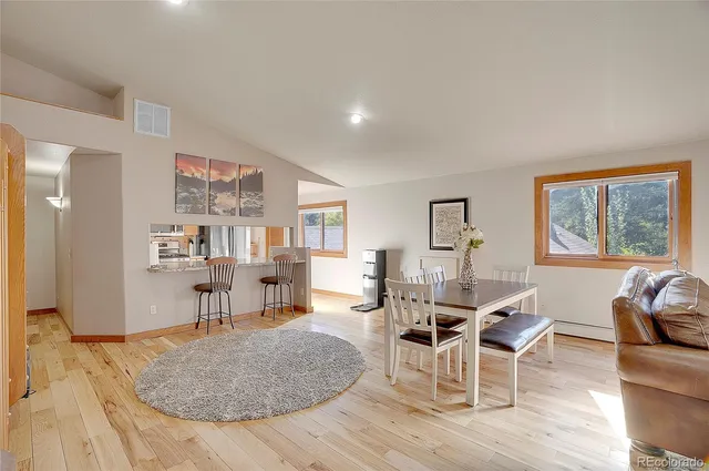 a living room with furniture a rug and a large window