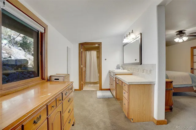a spacious bathroom with a sink and a large mirror