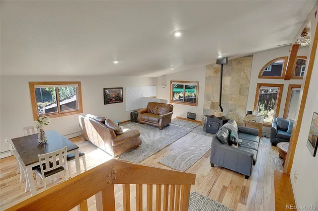 a living room with furniture window and a wooden floor