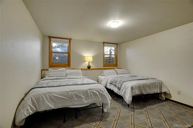 a bedroom with two beds and a window