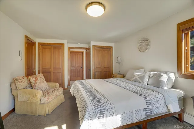 a bedroom with a bed and chandelier