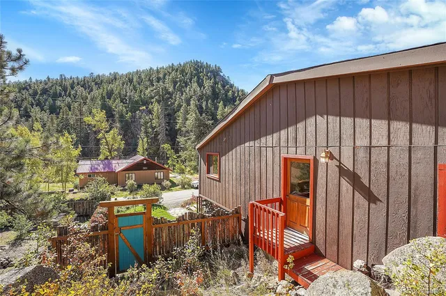 a backyard of a house with table and chairs