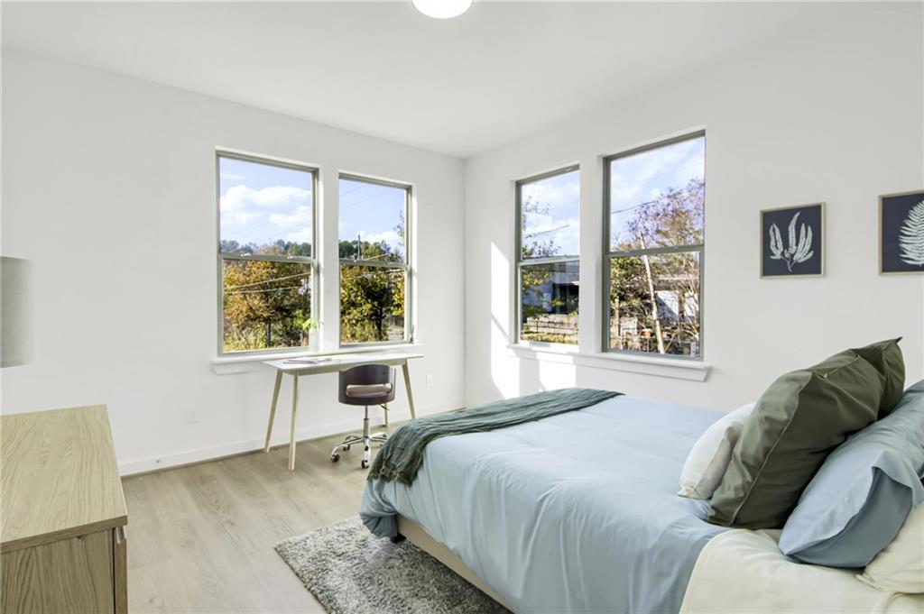 1070 Dill Avenue Southwest, Unit 201 Atlanta, GA 30310 - Photo 11 of 17 a bedroom with a bed and a large window