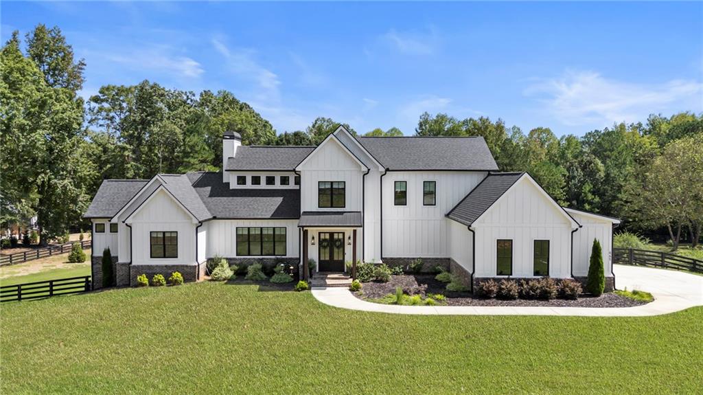 445 Roper Road Canton, GA 30115 - Photo 1 of 1 a front view of a house with garage and yard