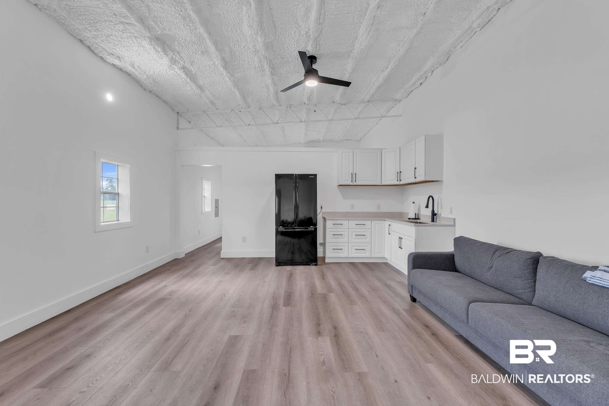 22592 Pastoral Lane Foley, AL 36535 - Photo 28 of 45 Living area featuring light wood-style flooring, ceiling fan, a textured ceiling, and lofted ceiling