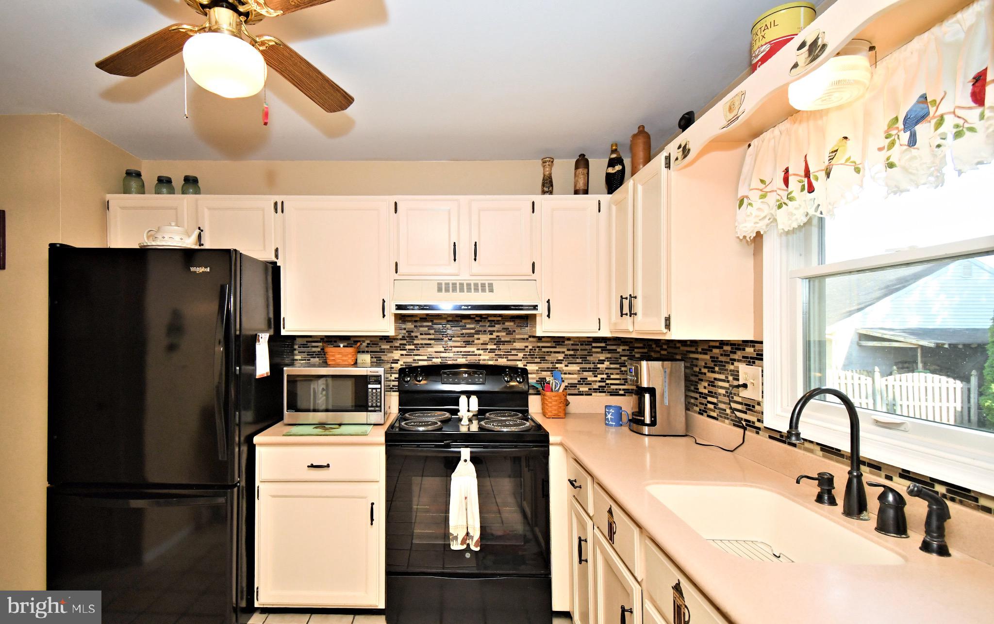 336 Arch Street Spring City, PA 19475 - Photo 15 of 58 a kitchen with a sink stainless steel appliances a chandelier and a counter top space
