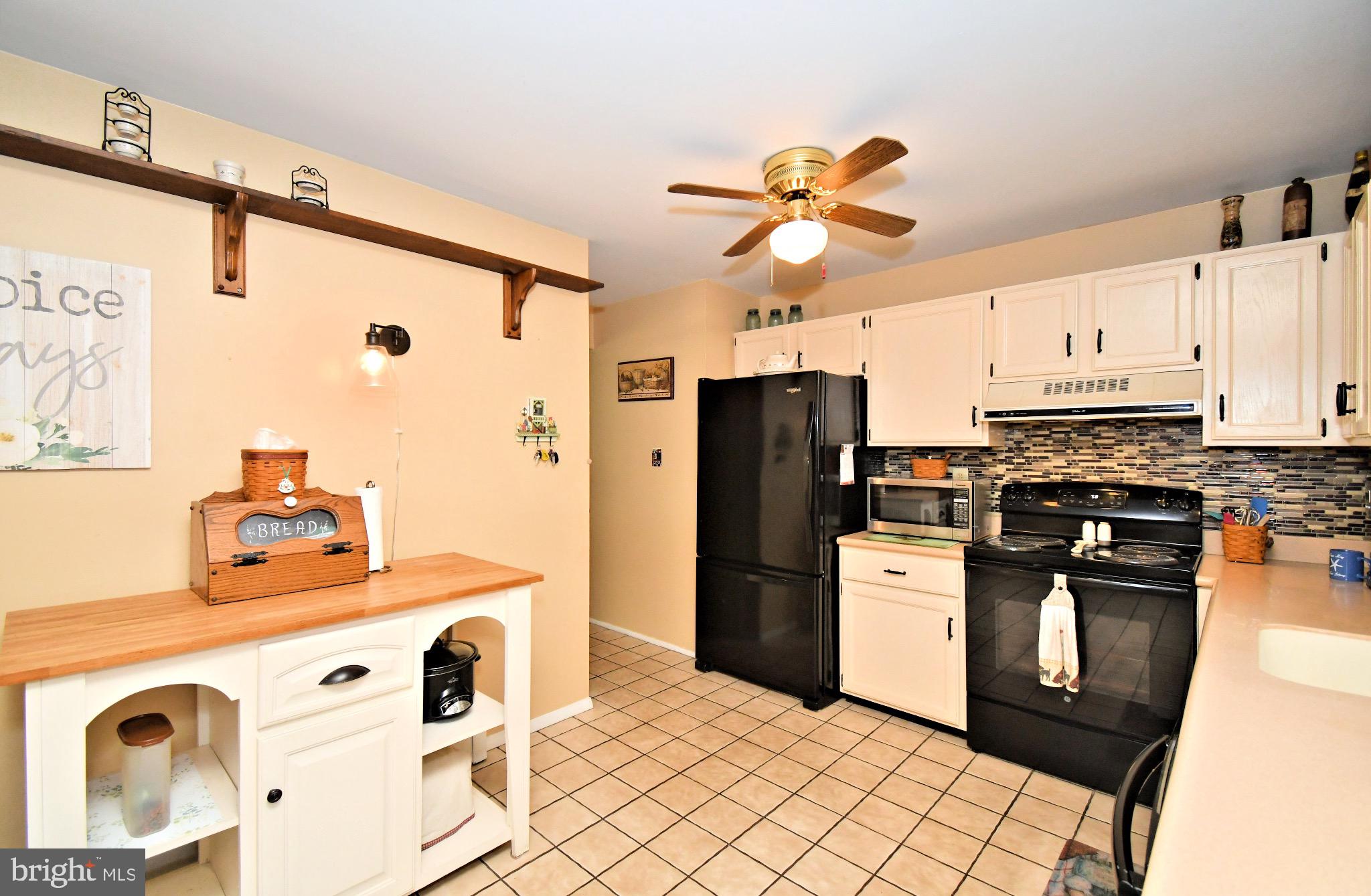 336 Arch Street Spring City, PA 19475 - Photo 16 of 58 a kitchen with stainless steel appliances granite countertop a refrigerator a stove a sink and white cabinets