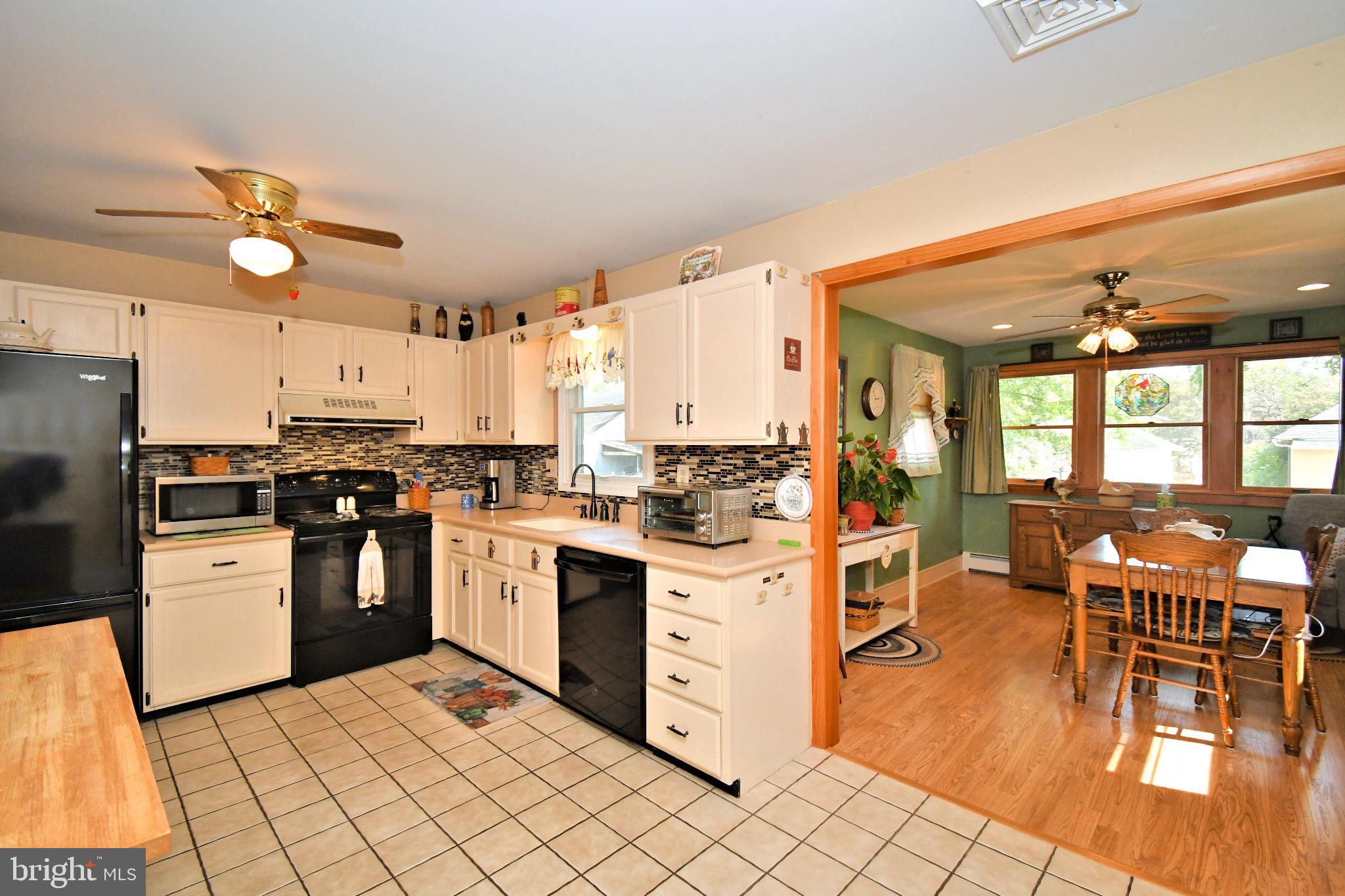 336 Arch Street Spring City, PA 19475 - Photo 17 of 58 a kitchen with stainless steel appliances granite countertop a stove top oven a refrigerator a dining table and chairs