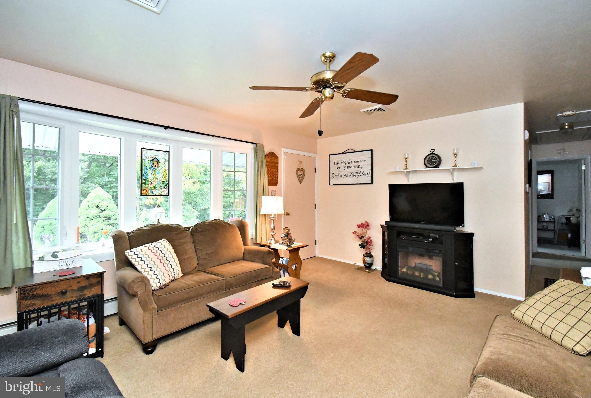336 Arch Street Spring City, PA 19475 - Photo 8 of 58 a living room with furniture a flat screen tv and a large window