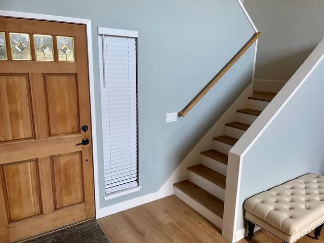 a view of entryway and hall with wooden floor