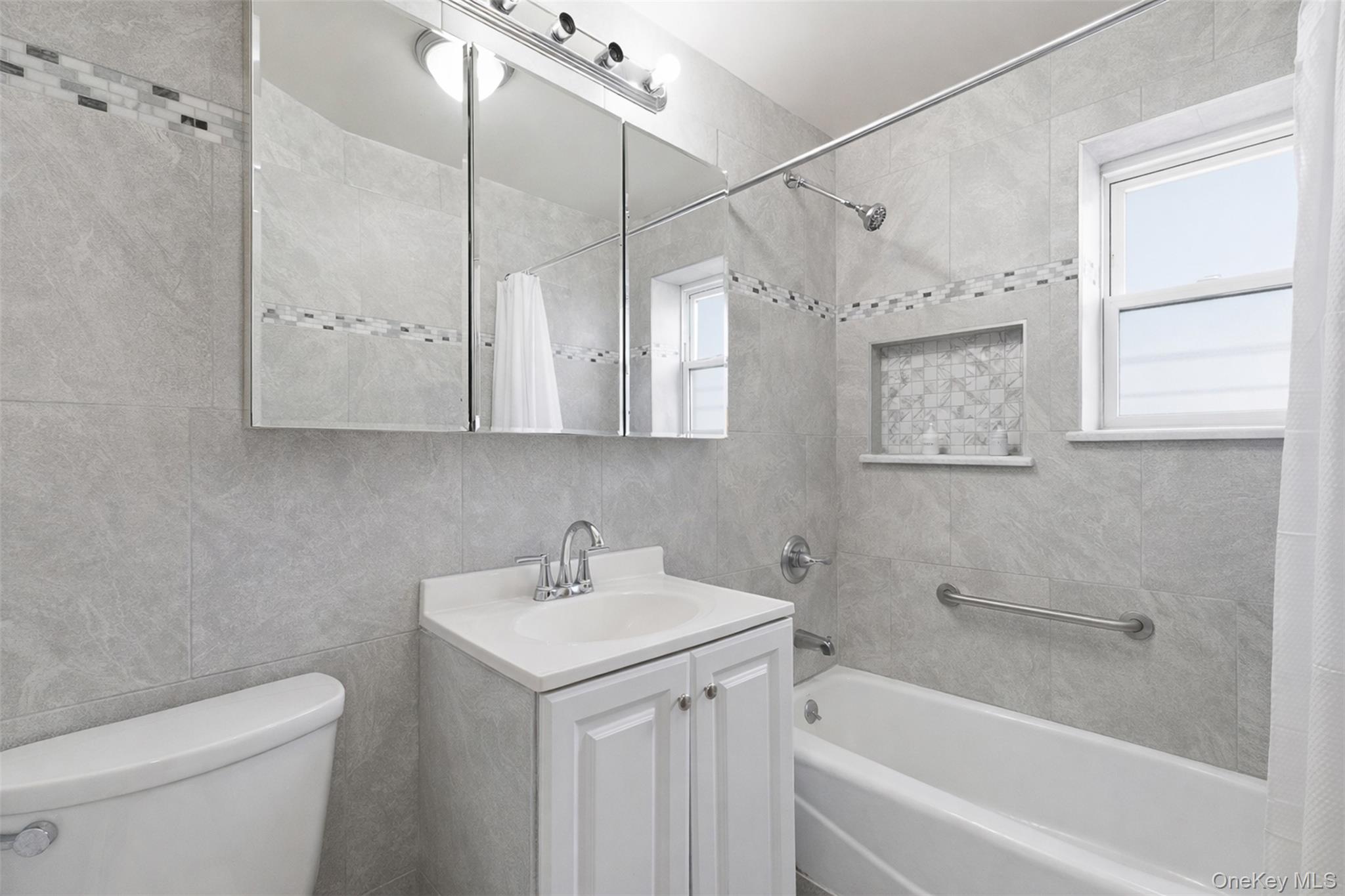 1677 Unionport Road Bronx, NY 10460 - Photo 11 of 33 Full bath with vanity, shower / bath combo with shower curtain, and tile walls