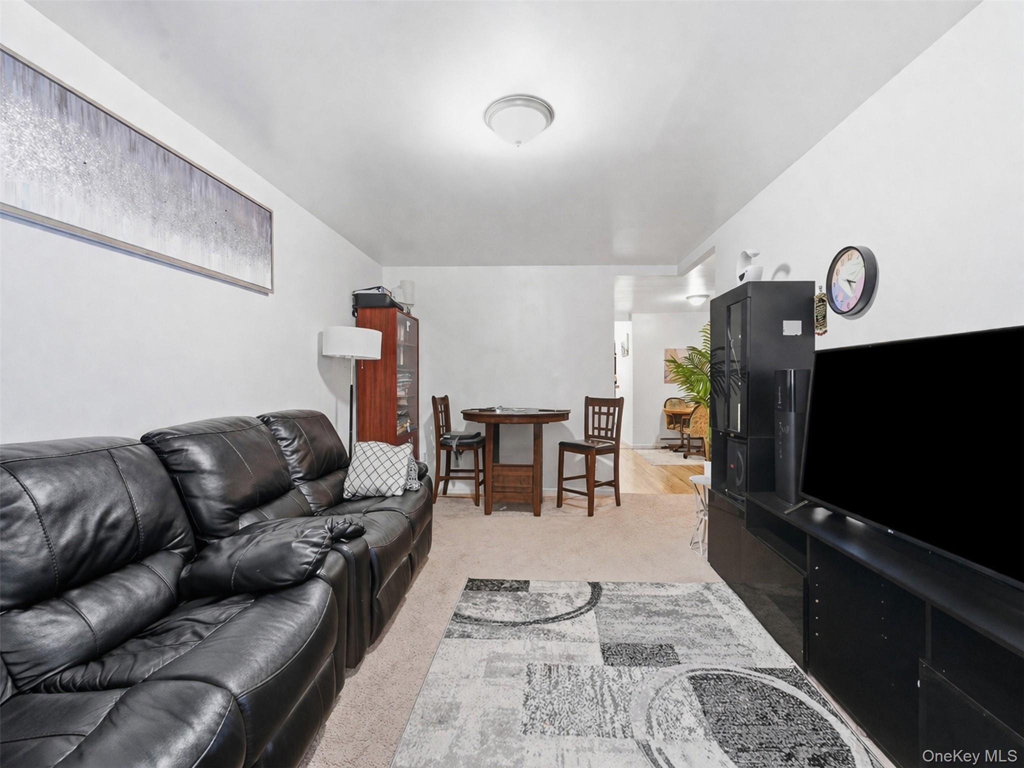 1677 Unionport Road Bronx, NY 10460 - Photo 19 of 33 Living room with light colored carpet