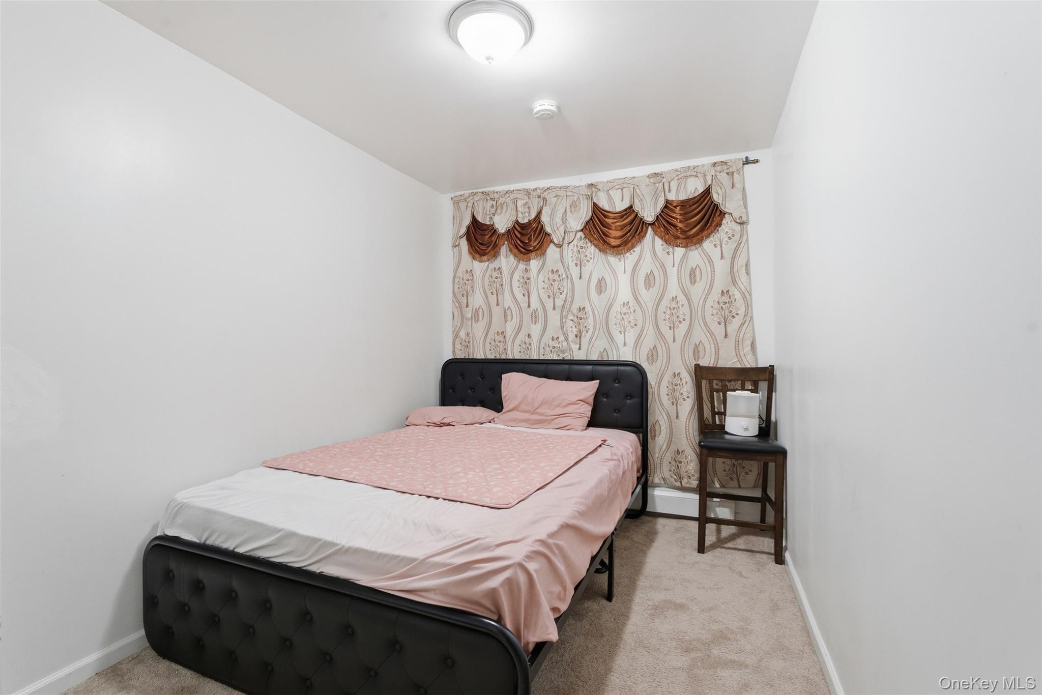 1677 Unionport Road Bronx, NY 10460 - Photo 22 of 33 Bedroom featuring light colored carpet and baseboards