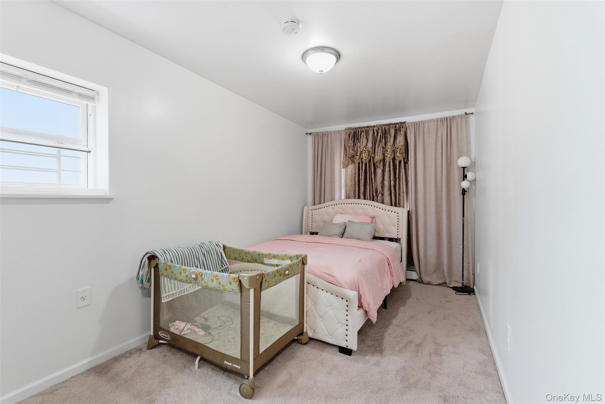 1677 Unionport Road Bronx, NY 10460 - Photo 24 of 33 Bedroom with light colored carpet