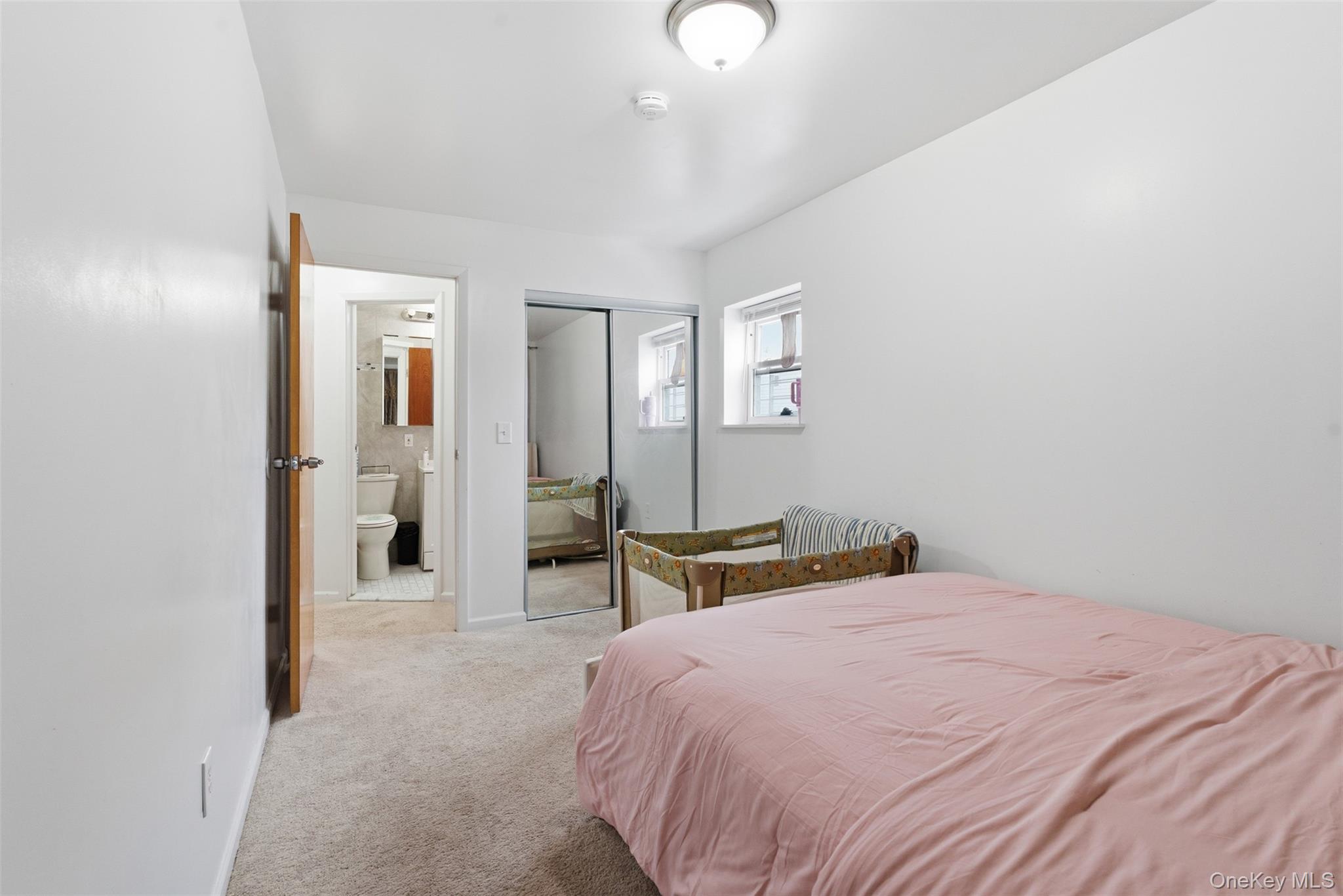 1677 Unionport Road Bronx, NY 10460 - Photo 25 of 33 Bedroom with light colored carpet and a closet