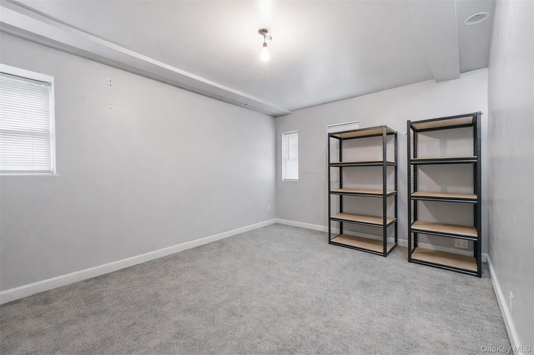 1677 Unionport Road Bronx, NY 10460 - Photo 29 of 33 Unfurnished room with light carpet and baseboards