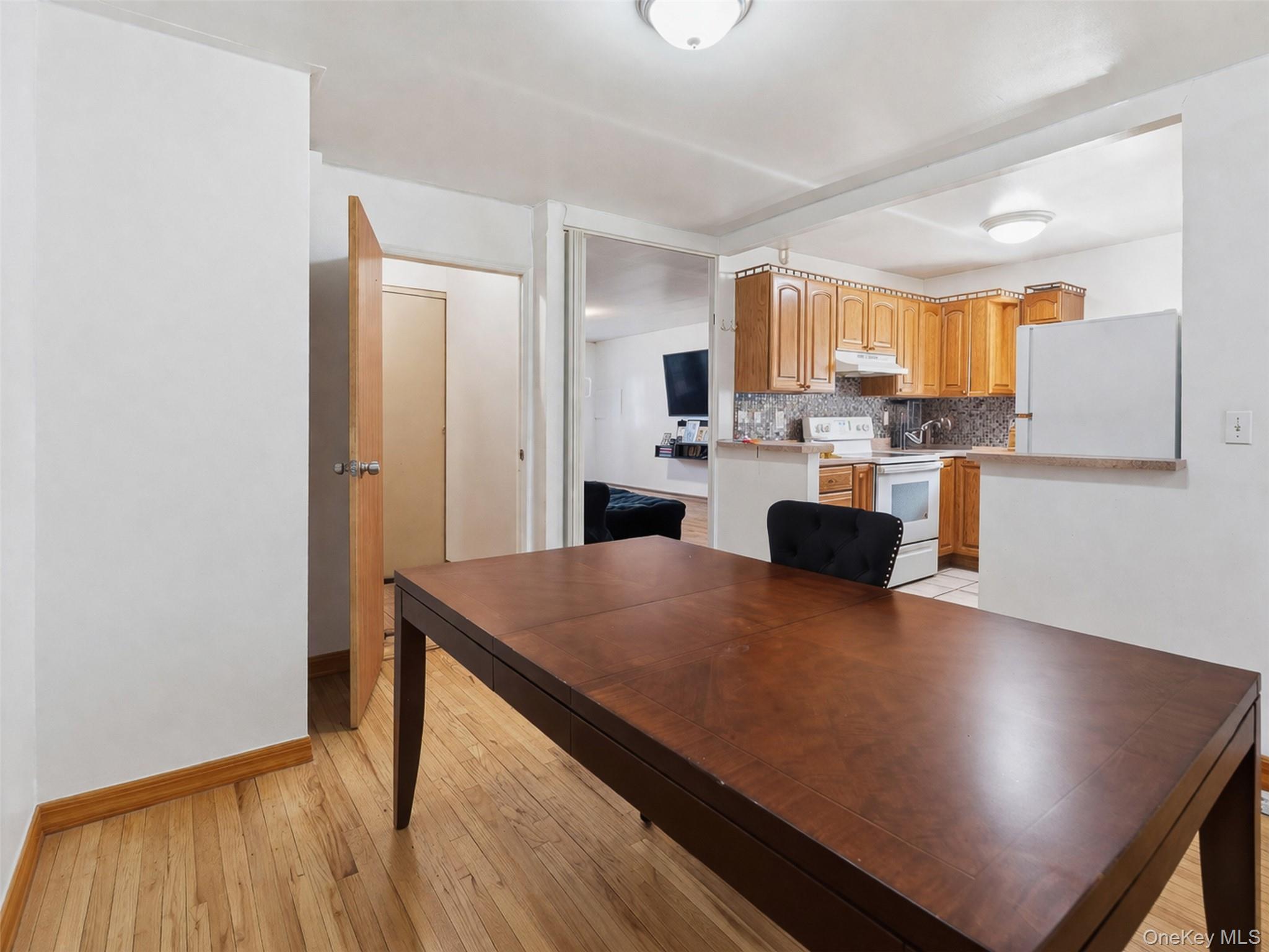 1677 Unionport Road Bronx, NY 10460 - Photo 4 of 33 Dining space with light wood-style flooring and baseboards