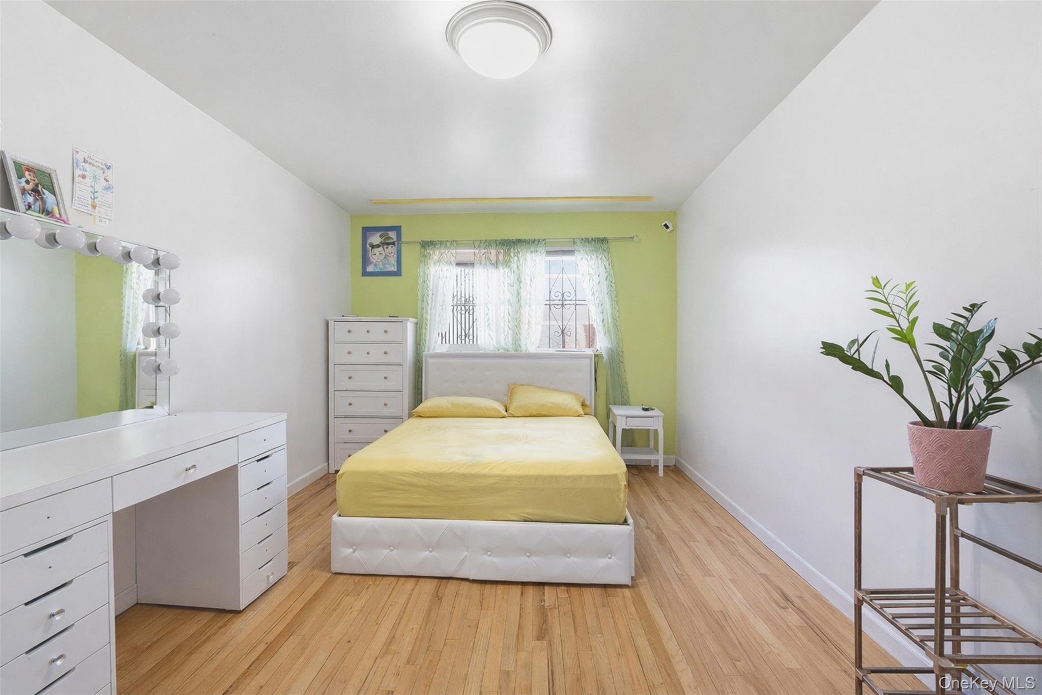 1677 Unionport Road Bronx, NY 10460 - Photo 7 of 33 Bedroom featuring light wood-style flooring and baseboards