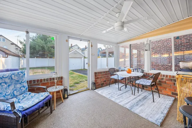 a dining room with furniture and a large window