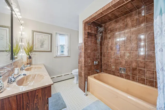 a bathroom with a tub a sink and a shower