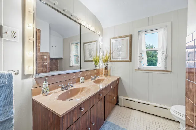 a bathroom with a sink mirror vanity and a bathtub
