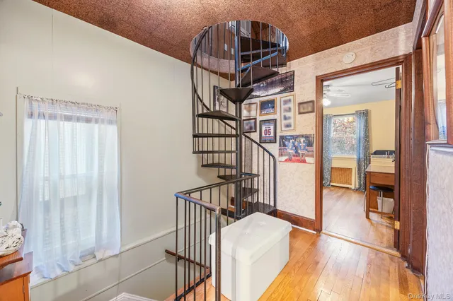 a view of entryway and hall with wooden floor