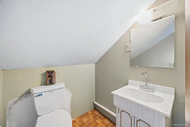 a bathroom with a sink a toilet and mirror