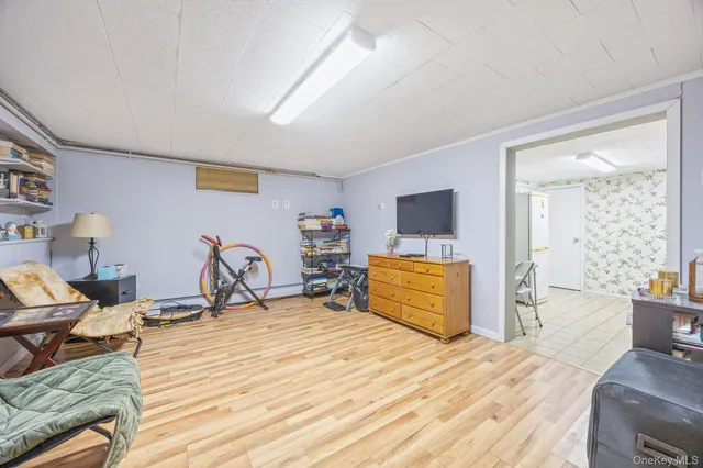 a bedroom with furniture and a flat screen tv