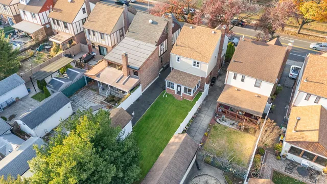 an aerial view of a house with a garden and lake view