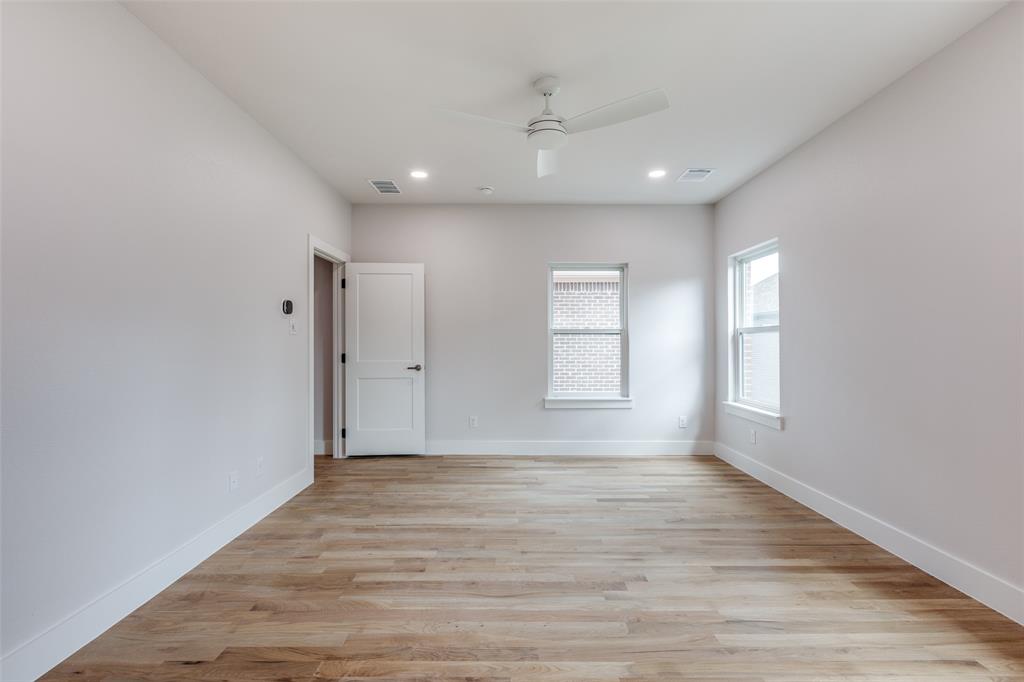 7139 Brisa Drive Dallas, TX 75223 - Photo 11 of 27 a view of an empty room with wooden floor and window