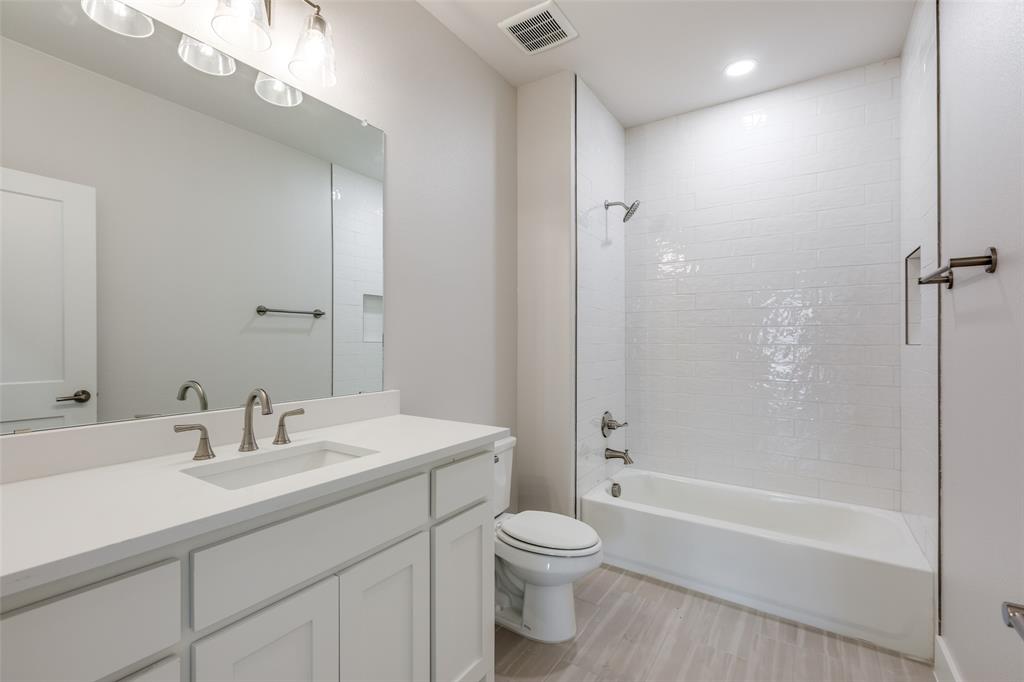 7139 Brisa Drive Dallas, TX 75223 - Photo 15 of 27 a bathroom with a sink a toilet and shower