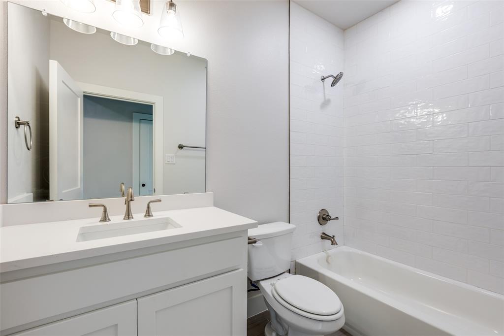 7139 Brisa Drive Dallas, TX 75223 - Photo 20 of 27 a bathroom with a sink a toilet and shower