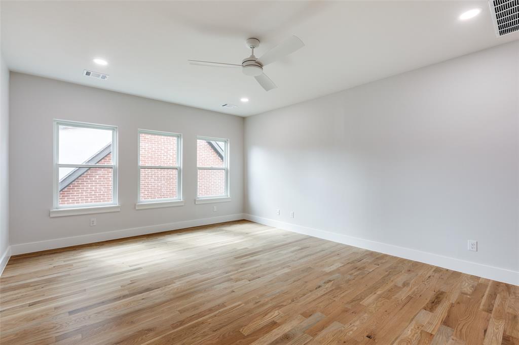 7139 Brisa Drive Dallas, TX 75223 - Photo 23 of 27 an empty room with wooden floor and windows