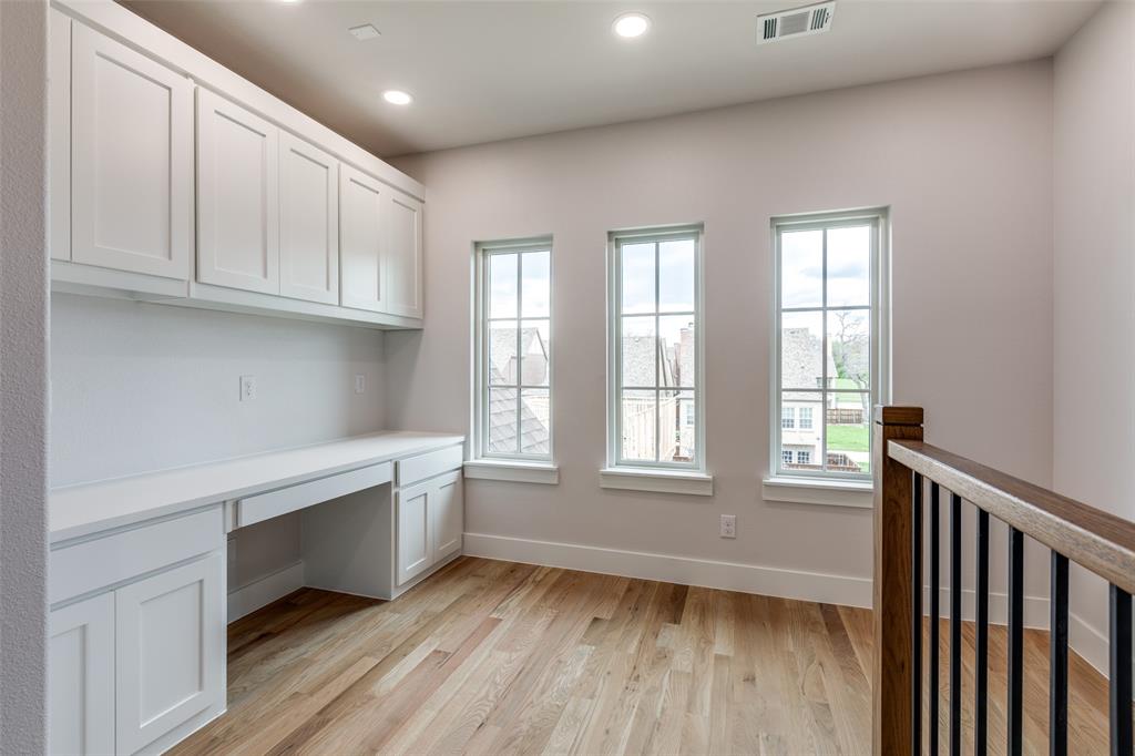 7139 Brisa Drive Dallas, TX 75223 - Photo 24 of 27 a view of an empty room with wooden floor and a window